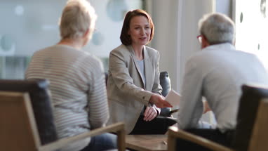 Senior couple shaking hands with financial advisor