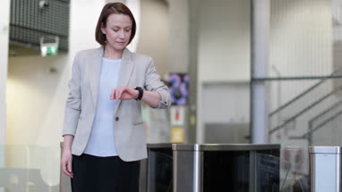 Businesswoman checking smartwatch as leaving office