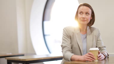 Businesswoman checking smartwatch in cafe