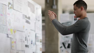 Designer taking photo of work with smartphone