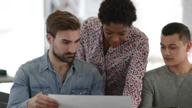 Designers looking at architectural plans in a creative workspace