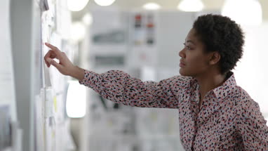 Designer looking at ideas on wall