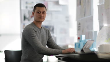 Young adult male working in creative office