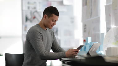 Young adult male working in creative office