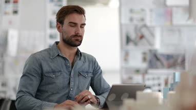 Young adult male working in creative office