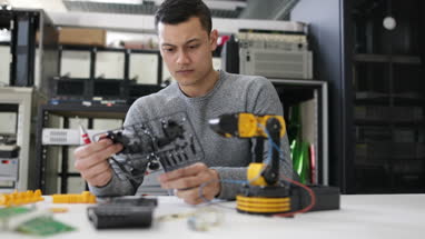 Young adult working on robotics