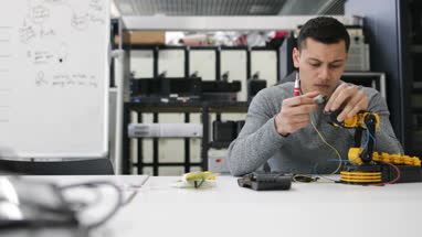 Young adult working on robotics