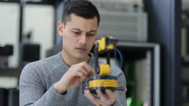 Young adult working on robotics
