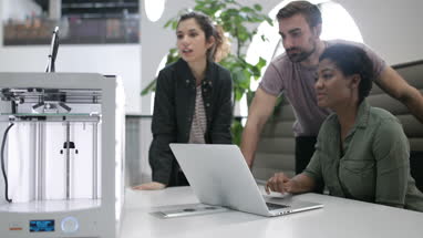 Team working with 3D printer