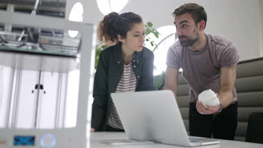 Team working with 3D printer