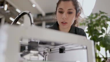 Female looking at 3D printer