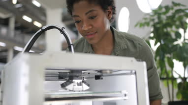 Female looking at 3D printer
