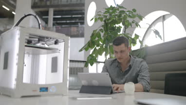 Male working on 3D printer design