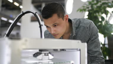 Male looking at 3D printer