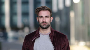 Portrait young adult male in city