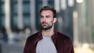 Portrait young adult male in city