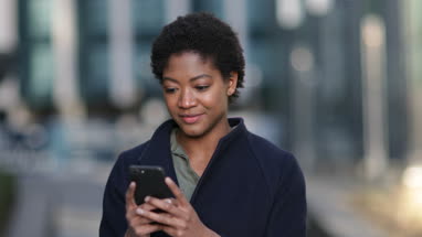 Young adult female using smartphone in city