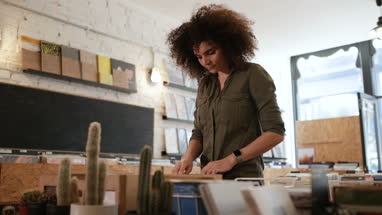 Young adult female looking for records in a store