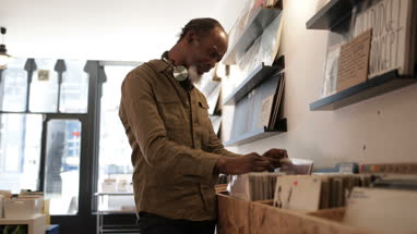 Senior male looking for records in a store