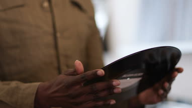 Closeup of senior male looking through records in a store