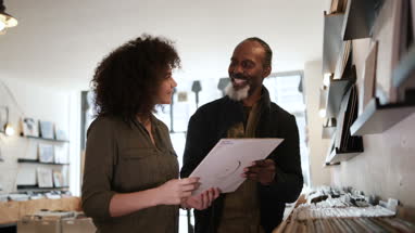 Store owner helping customer in a record store