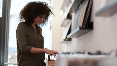 Young Adult female looking for records in a store