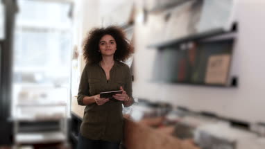 Portrait of small business owner using digital tablet in a record store