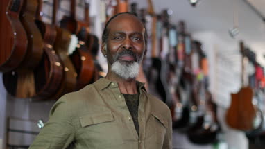 Portrait of a small business owner in a guitar store