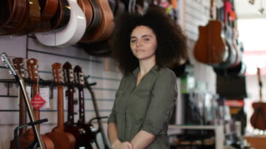 Portrait of a small business owner in a guitar store