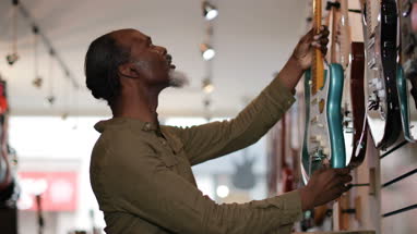 Senior male shopping in a guitar store