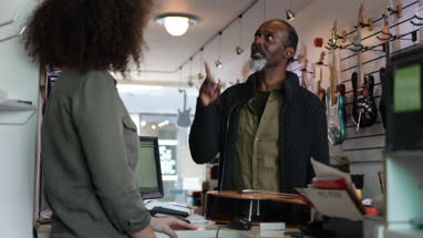 Senior male buying an acoustic guitar