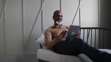 African American senior male using digital tablet