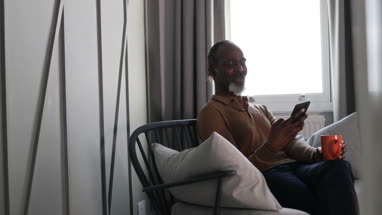 African American senior male using smartphone