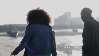 Father and Daughter walking on beach