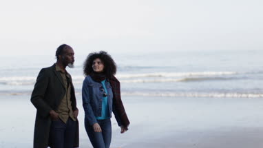 Father and Daughter walking on beach