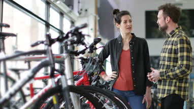 Small business owner serving customer in a bike store