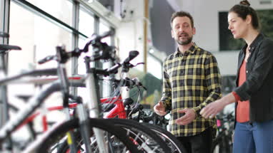 Small business owner serving customer in a bike store