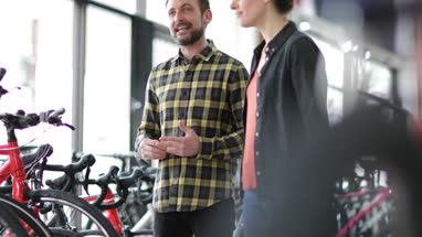 Small business owner serving customer in a bike store