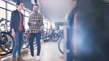 Small business owner serving customer in a bike store