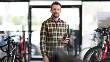 Portrait of a small business owner in a cycle store
