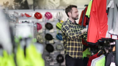 Adult male looking at sportswear in store