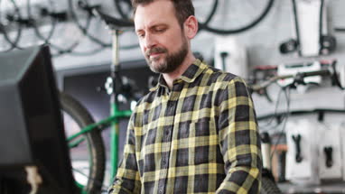 Small business owner using computer in a store