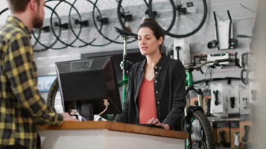 Small business owner serving customer in a bicycle store