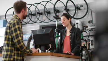 Small business owner serving customer in a bicycle store