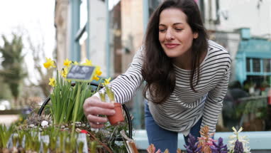 Woman shopping for plants at a street market