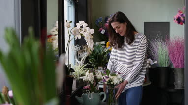 Adult female choosing flowers in a florist