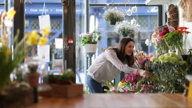 Florist pricing flowers in her store