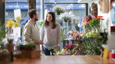 Florist serving customer in a store