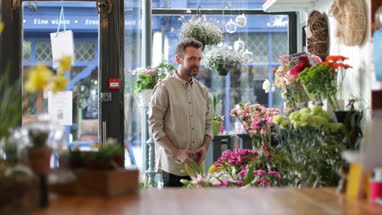 Male Florist working in store