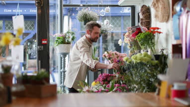 Small business owner using digital tablet in a florist